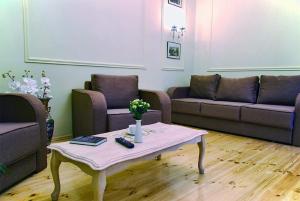 a living room with two couches and a coffee table at Classic Apartment on Zhukovskoho in Odesa
