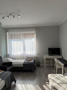 a living room with two beds and a television at Villa Rosa in Poznań
