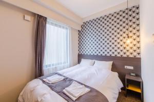 Voodi või voodid majutusasutuse Hotel M's Plus Shijo Omiya toas