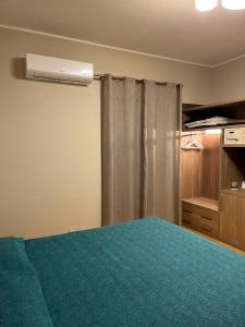 a bedroom with a green bed and a closet at Il Gabbiano in Termini Imerese