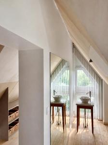 a bathroom with two sinks and a window at North Sea Cottage Middelkerke in Middelkerke