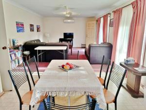 a living room with a table with a bowl of fruit on it at Kates Cottage in Aireys Inlet