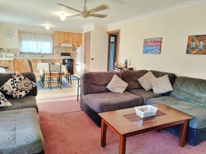 a living room with two couches and a coffee table at Kates Cottage in Aireys Inlet +8 photos