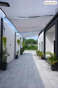 an empty hallway of a building with potted plants at Chenang Private Pool Villa & Cottage in Pantai Cenang +10 photos