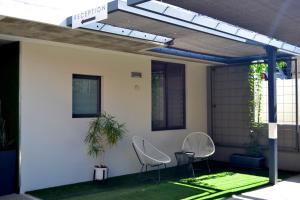a patio with two chairs and a table at iKON Apartments in Windhoek
