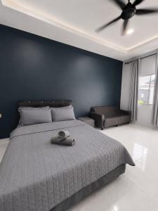 a bedroom with a bed with a ceiling fan at Chenang Private Pool Villa & Cottage in Pantai Cenang