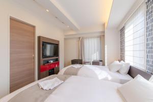 Voodi või voodid majutusasutuse Hotel M's Plus Shijo Omiya toas