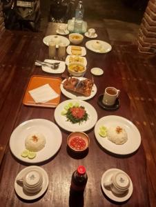 a table with white plates of food on it at Lentera Lombok in Tetebatu
