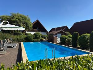 a swimming pool in the backyard of a house at Ferienwohnung mit Loggia im Teutoburger Wald in Bredenborn