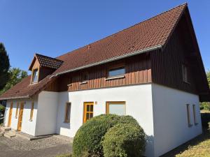 a large white house with a brown roof at Ferienwohnung mit Loggia im Teutoburger Wald in Bredenborn +34 photos