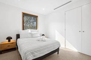 a bedroom with a bed with a stuffed animal on it at Bimbadeen Bliss in Aireys Inlet