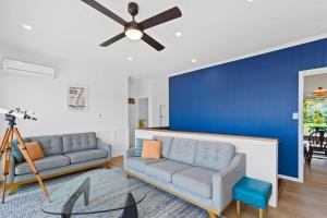 a living room with two couches and a blue wall at Casino Views in Apollo Bay