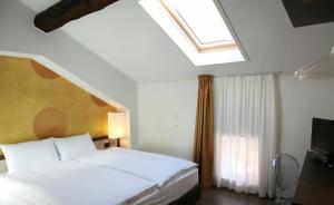 Ліжко або ліжка в номері Hotel Internazionale Bellinzona