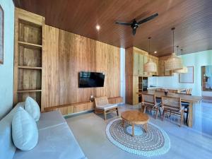 a living room with a couch and a table at Poka Ubud Hidden Paradise & Spa by EPS in Ubud