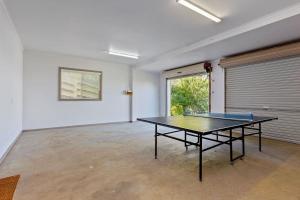 an empty room with a ping pong table in it at Otway Views in Apollo Bay