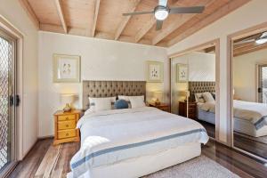a bedroom with two beds and a ceiling fan at Otway Views in Apollo Bay