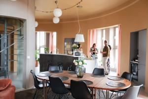 a dining room with a wooden table and chairs at Ystads Gamla Vattentorn in Ystad