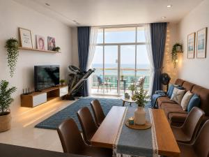 a living room with a couch and a table at Ocean Vista Mai House in Ấp Phú Tịnh (2)