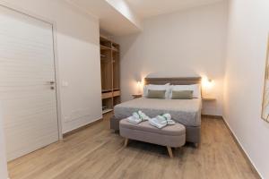 a bedroom with a bed and a chair with shoes on it at Ramo D'oro Relax Apartments in Ariccia