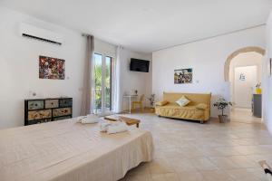 a large white room with a large bed and a couch at Sicilian Sea Breeze - Apartment in Bagheria