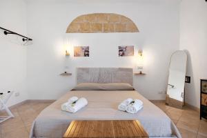 a bedroom with a bed with towels on it at Sicilian Sea Breeze - Apartment in Bagheria