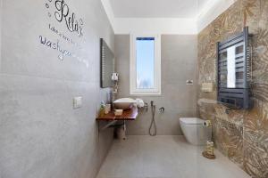 a bathroom with a sink and a toilet and a window at Sicilian Sea Breeze - Apartment in Bagheria +26 photos