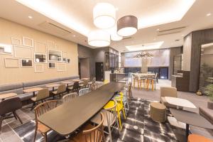 a dining room with tables and chairs and a bar at Hotel M's Plus Shijo Omiya in Kyoto