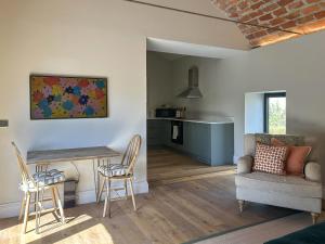 a living room with a couch and a table and chairs at The Lodge in Consett
