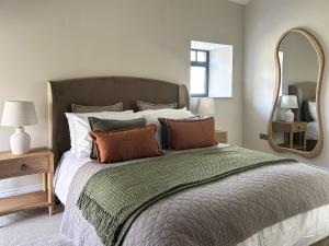 a bedroom with a large bed with a large mirror at The Lodge in Consett