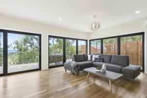 a living room with a couch and a table at Vue Sur La Mer in Wye River
