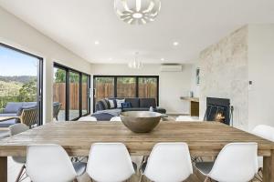 a living room with a large wooden table and chairs at Vue Sur La Mer in Wye River