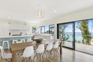 a kitchen and dining room with a table and chairs at Vue Sur La Mer in Wye River
