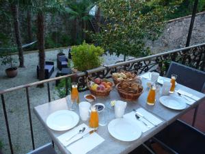 a table with plates of food and a basket of fruit at Le St Vincent in Roquefort