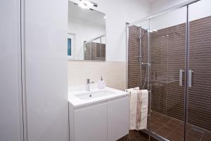 a bathroom with a sink and a shower at Argegno Pool apartment by Italian Apartments in Argegno +52 photos