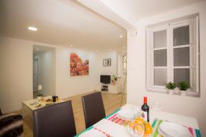 a living room with a table and a dining room at El Micalet Apartment in Valencia