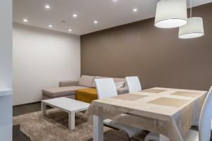 a dining room with a table and a couch at Marja Apartment in Põltsamaa
