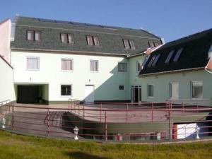 a large white building with a black roof at Belvárosi Panzió in Debrecen