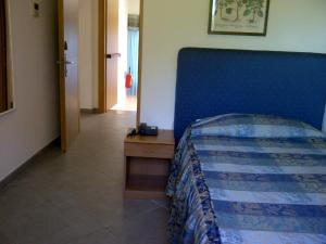 Postel nebo postele na pokoji v ubytování Albergo Rossella