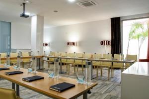 a conference room with wooden tables and chairs at Barceló Teguise Beach - Adults Only in Costa Teguise