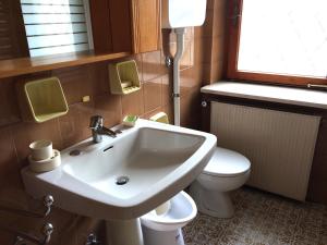a bathroom with a sink and a toilet at Villa Wanda in Cavalese
