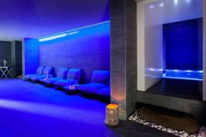 a living room with blue lighting and blue chairs at Barceló Teguise Beach - Adults Only in Costa Teguise