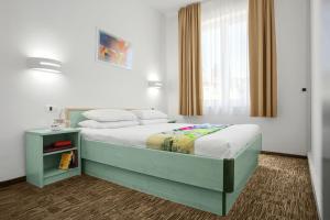 Postel nebo postele na pokoji v ubytování Lipa, Hotel & Bistro