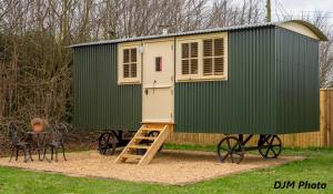 a green and white tiny house on wheels at Fourwinds B&B in March