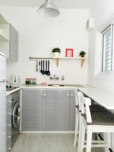 a kitchen with a sink and a dishwasher at Ikaria Village Studio in Paphos