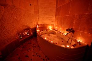 a bathroom with a tub with lights in it at Has Cave Konak in Ürgüp