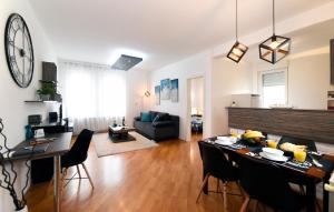 a living room with a dining table and a living room at Corner Apartment in Zagreb