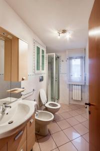 a bathroom with a toilet and a sink at Palazzo Giallo in Alba Adriatica