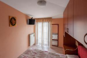 a bedroom with a bed and a large window at Palazzo Giallo in Alba Adriatica