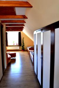 a room with a hallway with a bed and a window at Domek u Darka in Kielce