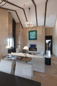 a living room with a couch and chairs and a chandelier at Ilgaz Mountain Resort Hotel in Ilgaz